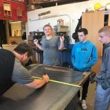 Image: Mr. Hutzel and students working on signs